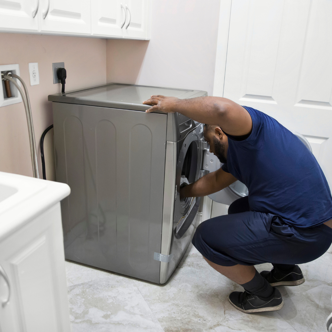 Technician repairing dryer components