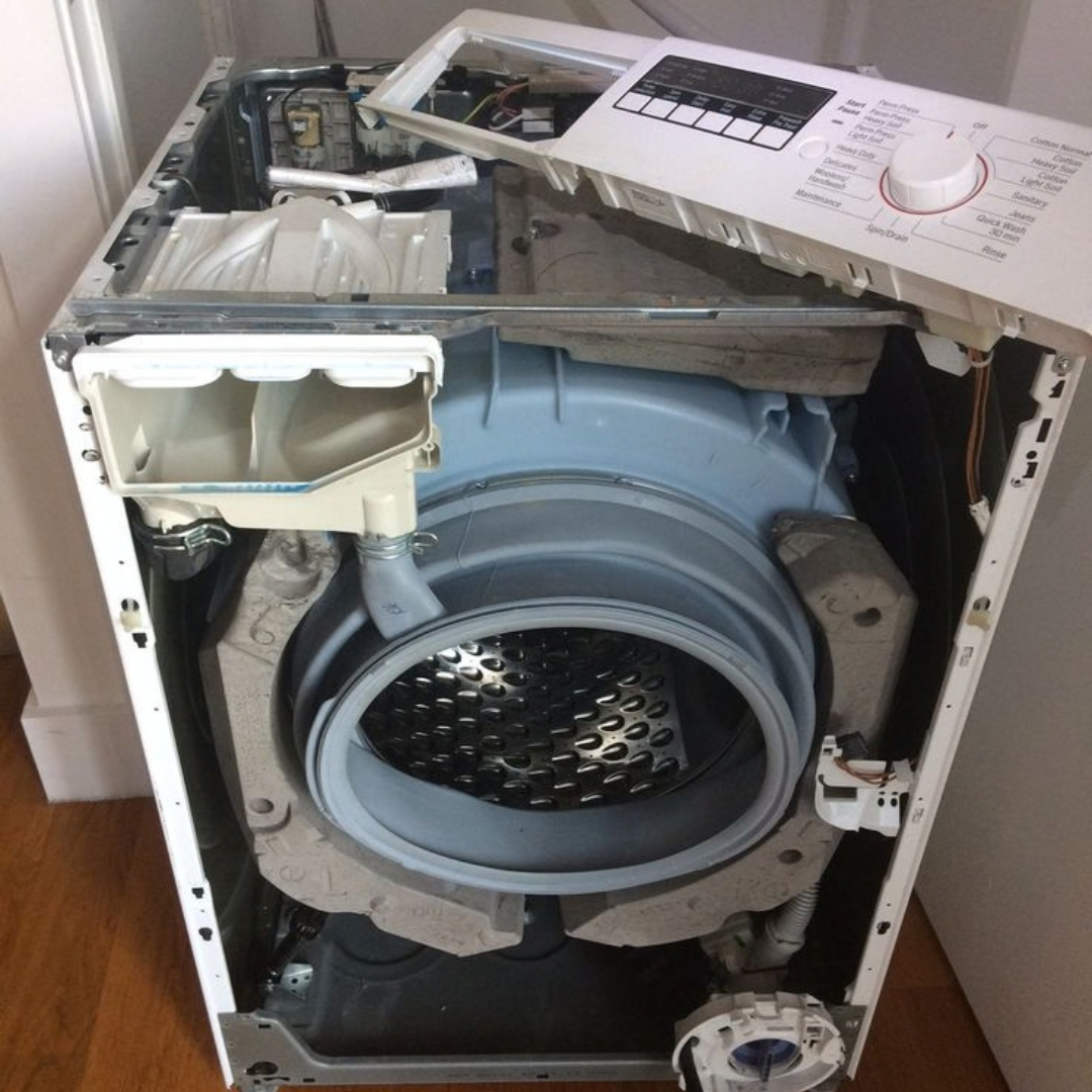 Technician repairing washing machine components