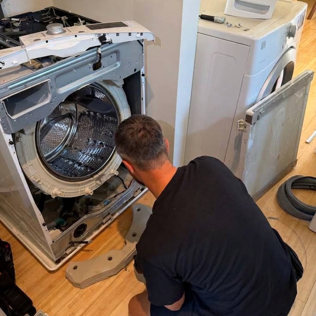 Washer repair technician diagnosing a washing machine